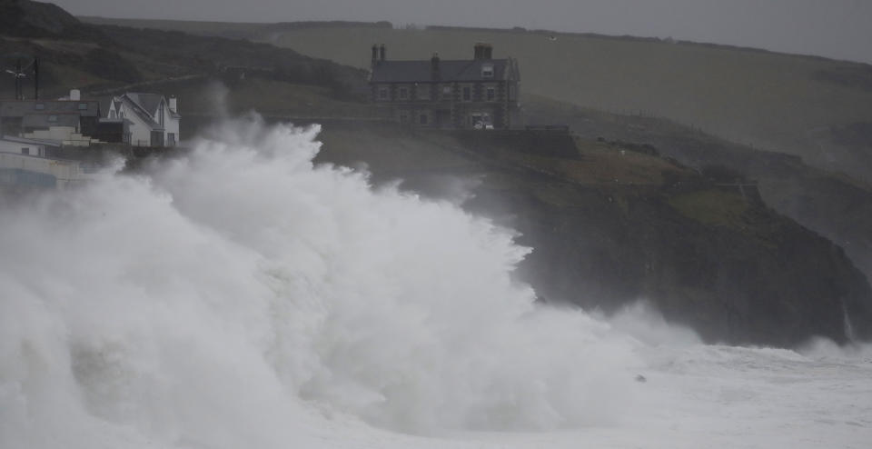 Powerful waves break on the shoreline around the small port of Porthleven, south west England, Sunday, Feb. 16, 2020. Storm Dennis roared across Britain on Sunday, lashing towns and cities with high winds and dumping so much rain that authorities urged residents to protect themselves from "life-threatening floods" in Wales and Scotland. (AP Photo/Alastair Grant)