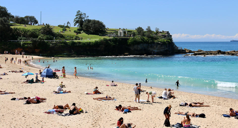 People at Coogee beach in Sydney on a sunny day. 