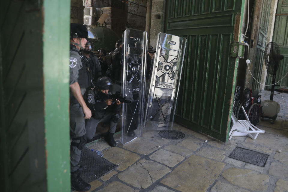 Israeli security forces take positions during clashes with Palestinians in front of the Dome of the Rock Mosque at the Al Aqsa Mosque compound in Jerusalem's Old City, Friday, June 18, 2021. (AP Photo/Mahmoud Illean)