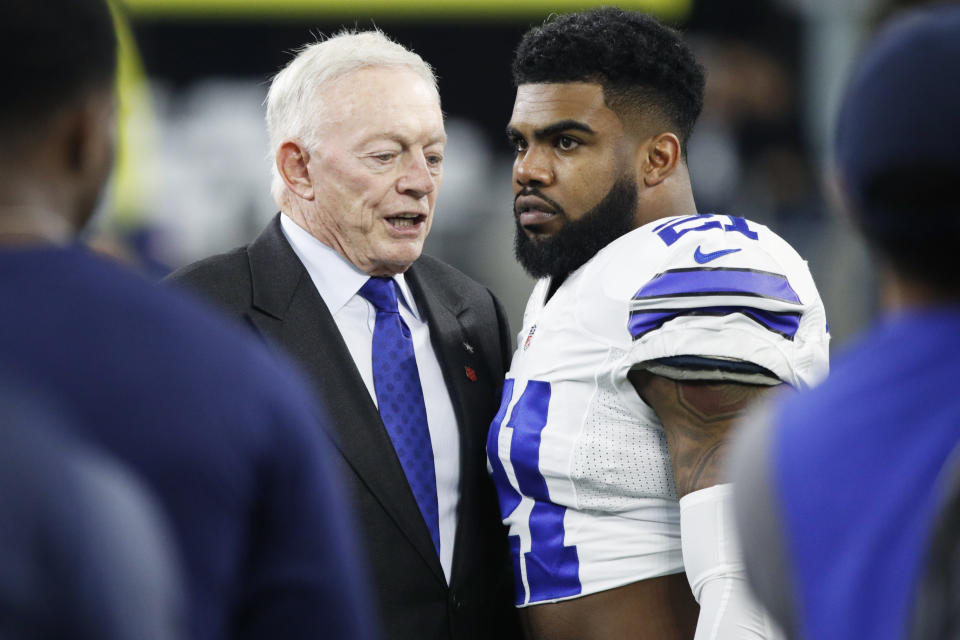 Ezekiel Elliott, right, reportedly won't play for the Cowboys in 2019 without a new contract; team owner/GM Jerry Jones says he's not worried about getting a deal done. (Getty Images)