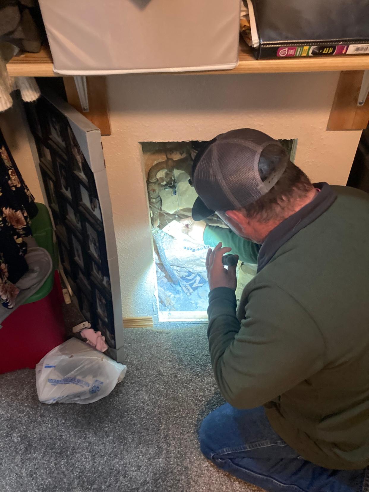 An inspector from the Great Falls Public Works Department inspects a home for the presence of lead or galvanized steel water pipes. Toughening regulations on exposure to lead will require hundreds of Great Falls homeowners to replace their water lines.