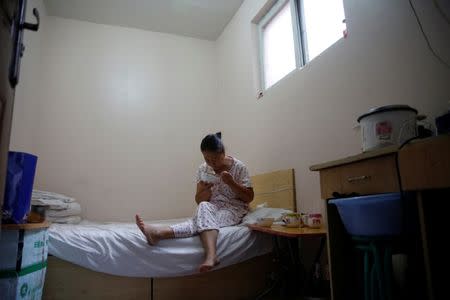 Wang eats breakfast, which her husband Liu cooked, in her room at the accommodation where some patients and their family members stay while seeking medical treatment in Beijing, China, June 23, 2016. REUTERS/Kim Kyung-Hoon