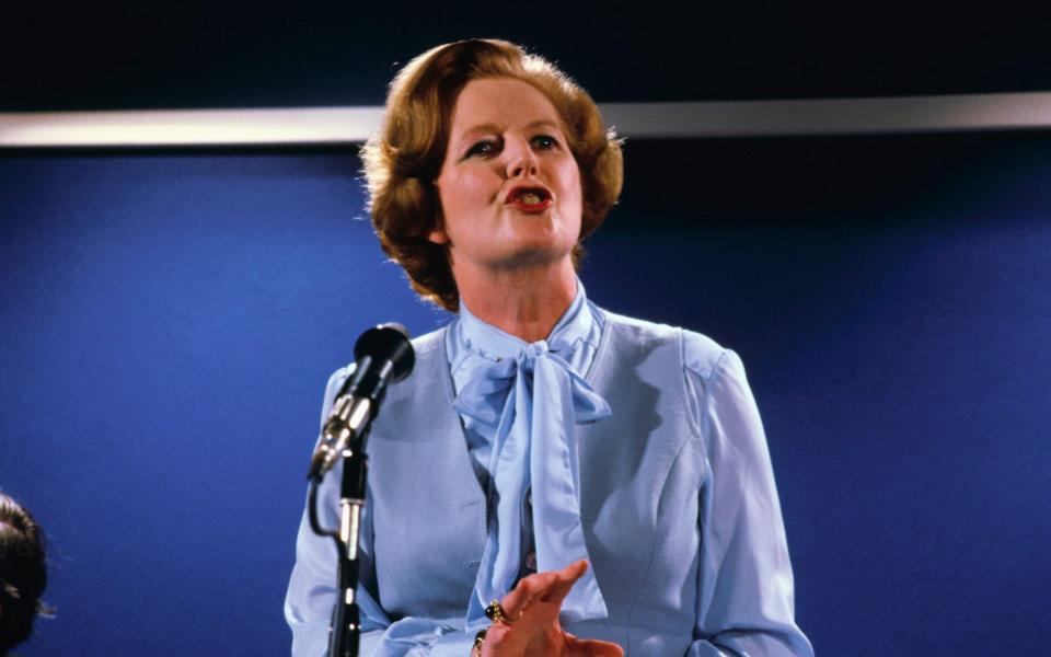 Margaret Thatcher wearing a blue pussy-bow blouse at a press conference in 1979 - Bettmann