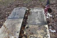 This Dec. 10, 2019, photo shows the headstones of Josiah Clark, a Revolutionary War soldier, and his wife, that were removed from a cemetery near the edge of an eroding river bank in Weybridge, Vt. Rising seas, erosion and flooding from worsening storms that some scientists believe are caused by climate change are putting some older graveyards across the country at risk. (AP Photo/Lisa Rathke)