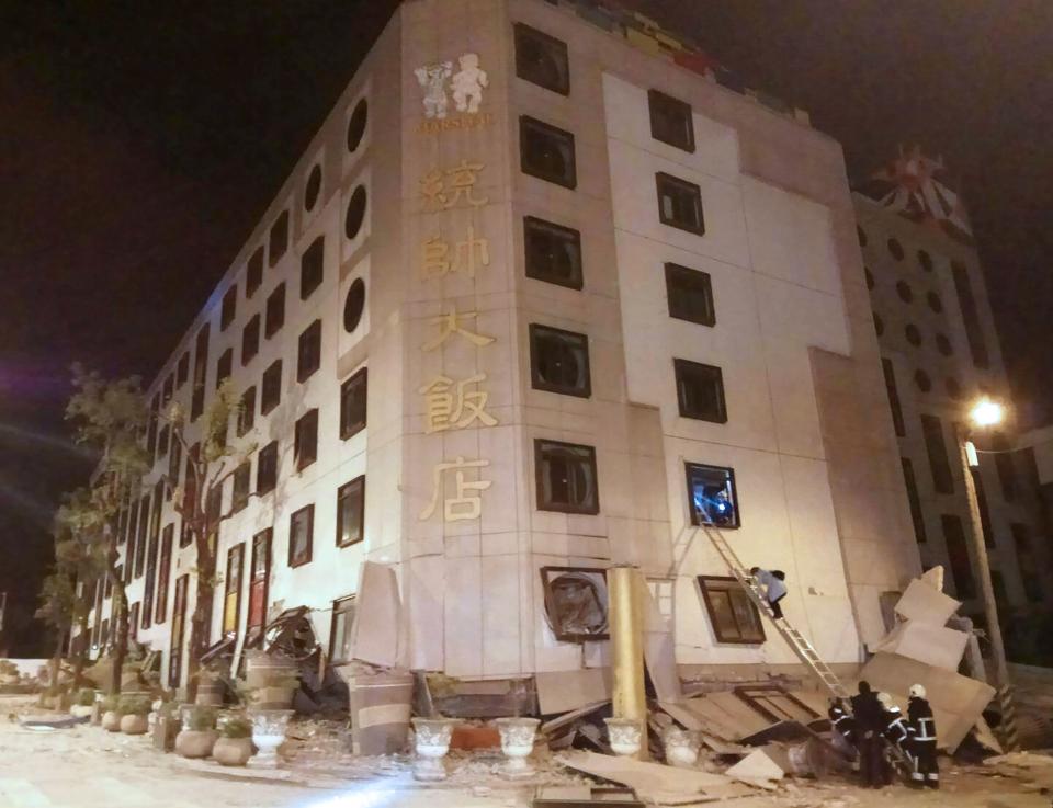 <p>Rescue workers search through rubble outside the Marshal Hotel in Hualien, eastern Taiwan early Feb. 7, 2018, after a strong earthquake struck the island.<br> (Photo: AFP/Getty Images) </p>