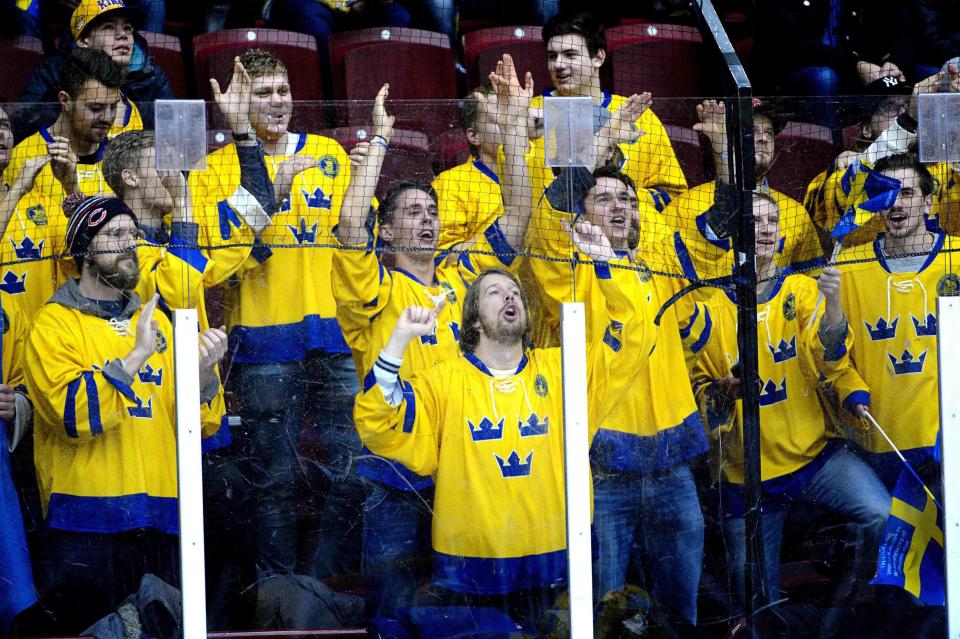 Swedish fans cheer their team on as they warm up before the IIHF World Junior Championship Group B preliminary round ice hockey match between Sweden and Finland at Malmo Arena in Malmo, December 28, 2013. REUTERS/Ludvig Thunman/TT News Agency (SWEDEN - Tags: SPORT ICE HOCKEY) ATTENTION EDITORS - THIS IMAGE HAS BEEN SUPPLIED BY A THIRD PARTY. IT IS DISTRIBUTED, EXACTLY AS RECEIVED BY REUTERS, AS A SERVICE TO CLIENTS. SWEDEN OUT. NO COMMERCIAL OR EDITORIAL SALES IN SWEDEN. NO COMMERCIAL SALES