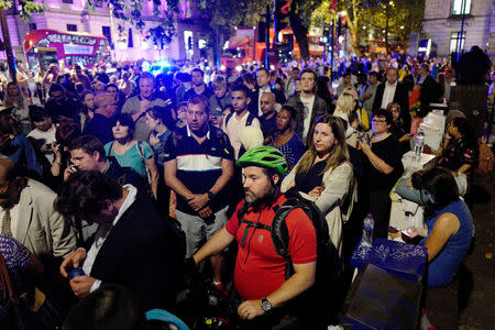 Commuters are seen outside Euston Station after police evacuated the area following a security alert in London, Britain, August 29, 2017. REUTERS/Tolga Akmen