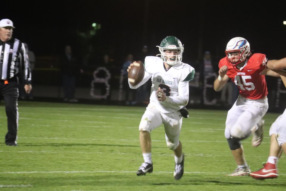 Oak Harbor's Mike LaLonde scrambles to throw.