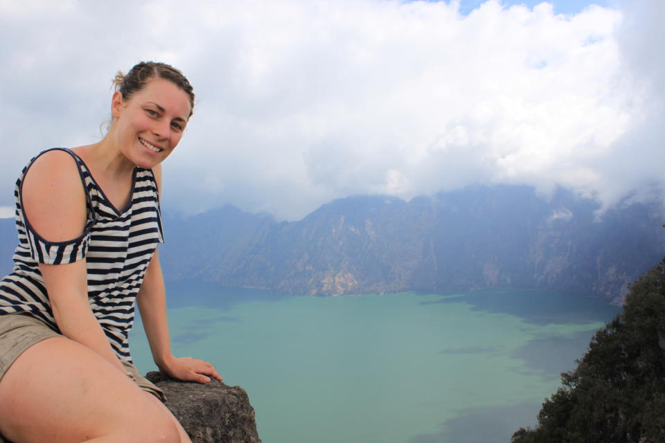 Sarah Frazer pictured on a mountain overlooking a bay. 