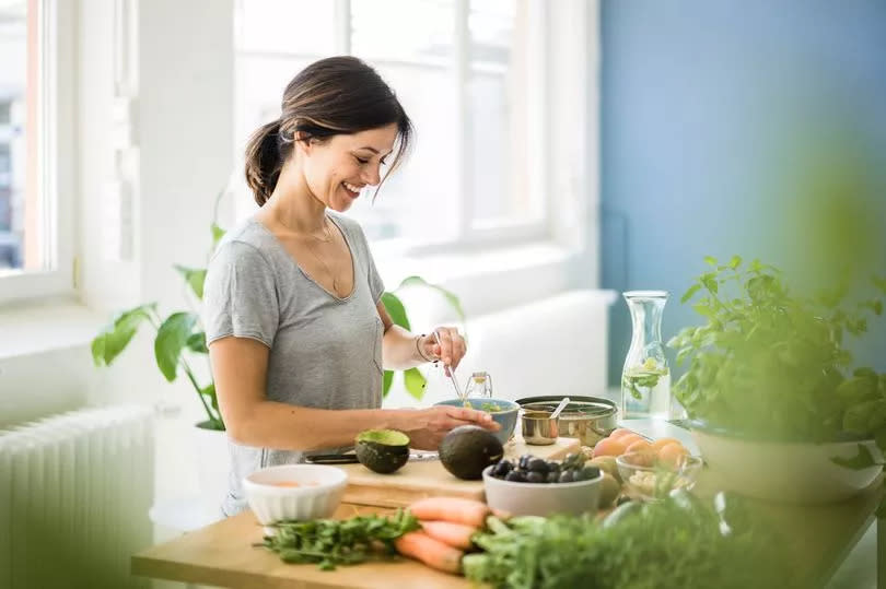 Woman preparing healthy food in her kitchen