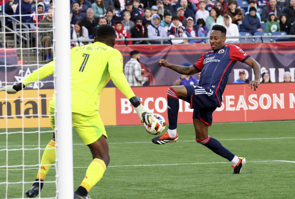 New England Revolution midfielder Mark-Anthony Kaye attempts to score against Toronto FC goalkeeper Sean Johnson (1) in the second half of an MLS soccer match, Sunday, March 3, 2024, in Foxborough, Mass. (AP Photo/Mark Stockwell)