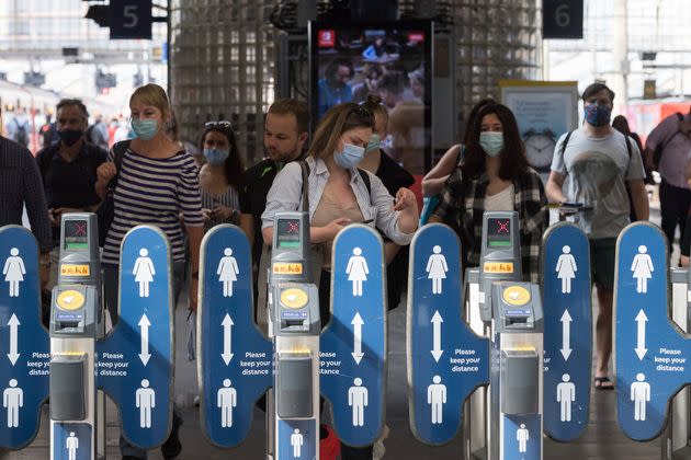 Commuters, most of them continuing to wear face masks, at Waterloo station (Photo: Anadolu Agency via Getty Images)