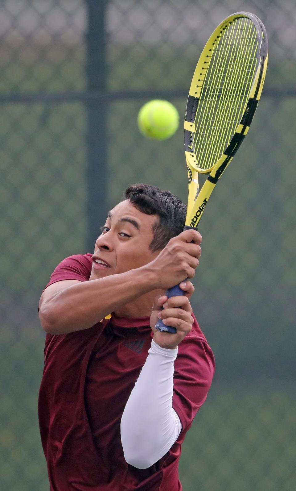 Walsh Jesuit's Caleb Miller sends a shot back over the net  during a tennis match against Brecksville on Wednesday.