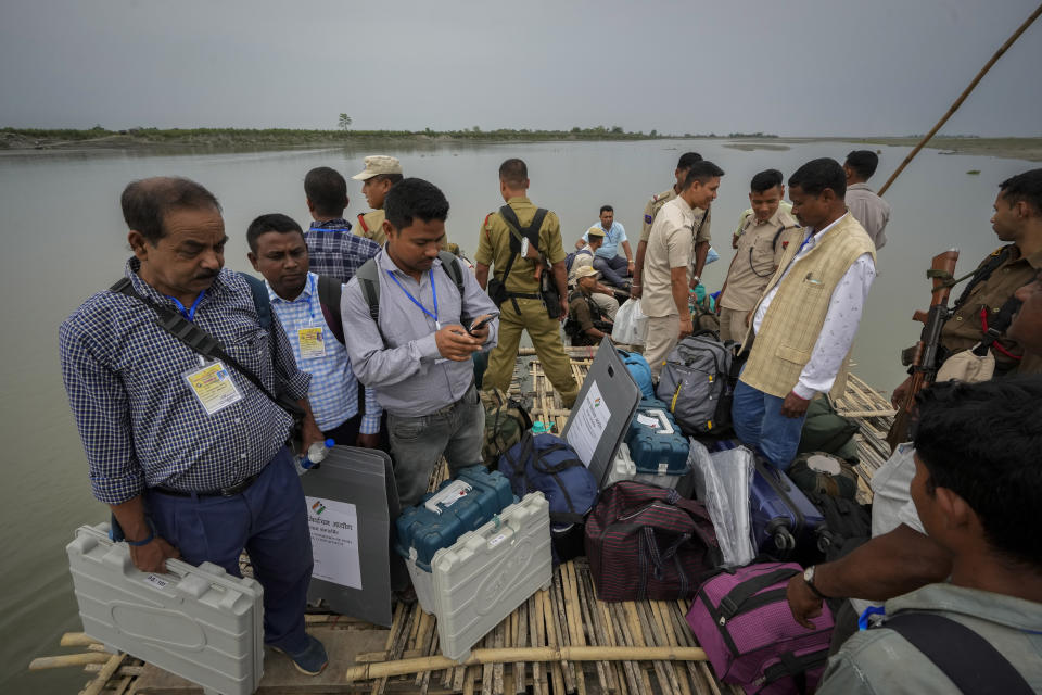 Polling officials and security personnel headed to a remote polling booth travel on a boat to cross the river Brahmaputra on the eve of parliament election at Baghmora Chapori (small island) of Majuli, northeastern Assam, India, April 18, 2024. (AP Photo/Anupam Nath)