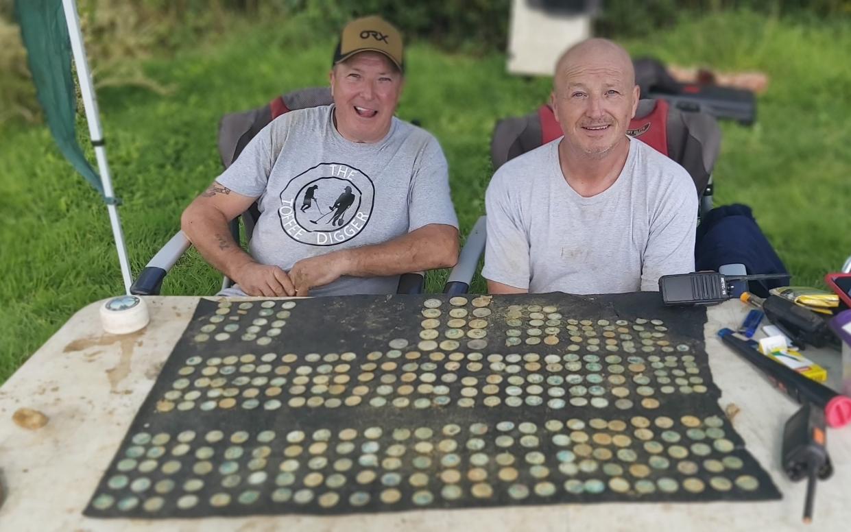 John McGimpsey, left, with his brother David and the hoard of forged coins