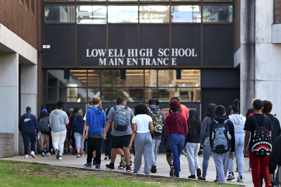 About 20 students walking into high school building