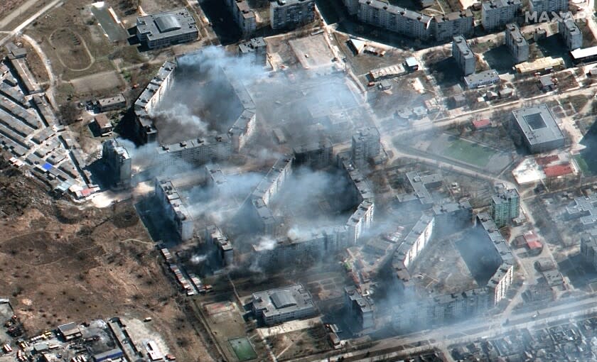 This satellite image provided by Maxar Technologies shows burning apartment building in northeastern Mariupol, Ukraine during the Russian invasion on Saturday, March 19, 2022. (Satellite image ©2022 Maxar Technologies via AP)