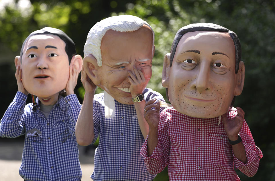 Activists from Oxfam wear giant heads depicting G7 leaders during a demonstration in Munich, Germany, Saturday, June 25, 2022. The G7 Summit will take place at Castle Elmau near Garmisch-Partenkirchen from June 26 through June 28, 2022. Leaders depicted from left, Japan's Prime Minister Fumio Kishida U.S. President Joe Biden and Italy's Prime Minister Mario Draghi. (AP Photo/Matthias Schrader)