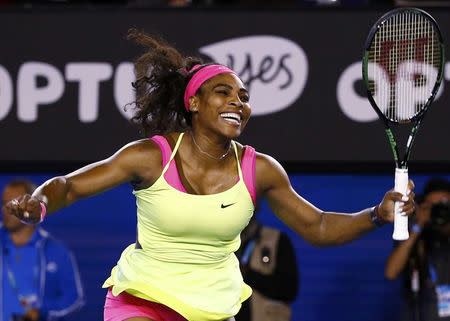 Serena Williams of the U.S. celebrates after defeating Maria Sharapova of Russia in their women's singles final match at the Australian Open 2015 tennis tournament in Melbourne January 31, 2015. REUTERS/Issei Kato