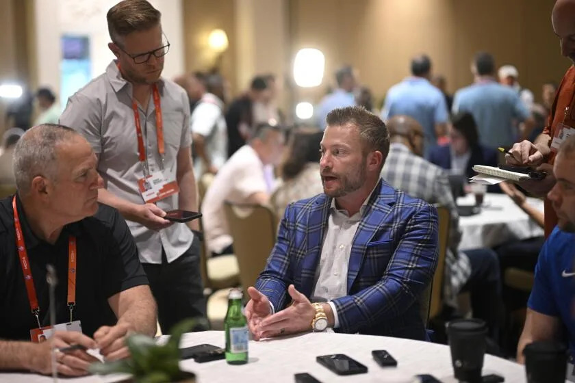 Rams coach Sean McVay (center) talks with reporters during availability at the NFL owners meetings.