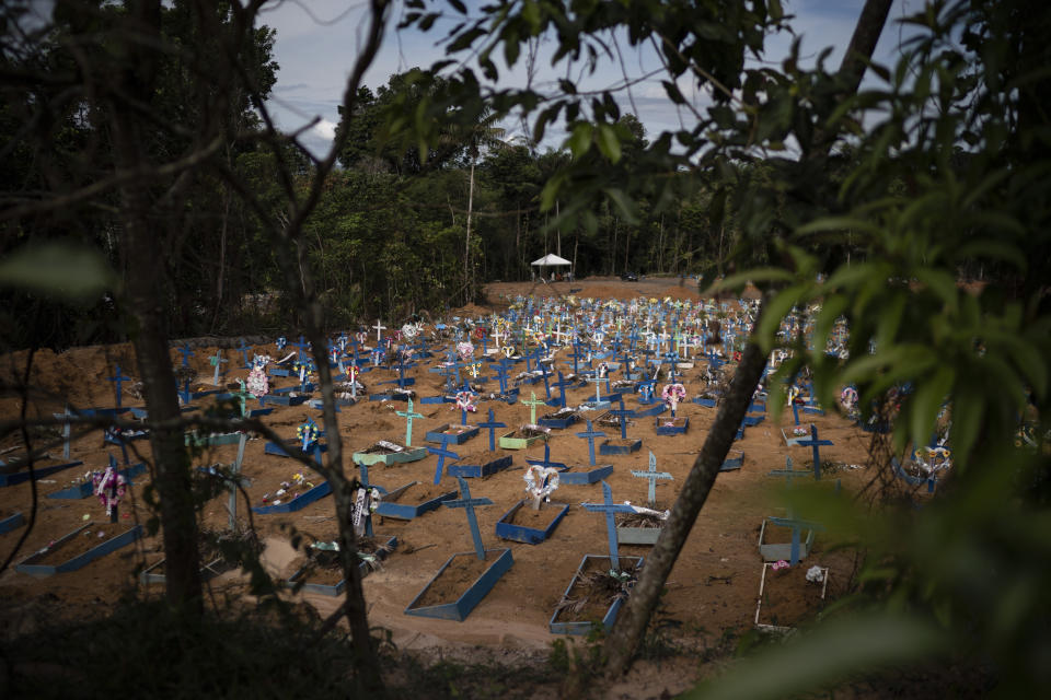 In this May 11, 2020 photo, graves for people who have died in the past month fill a new section of the Nossa Senhora Aparecida cemetery, amid the new coronavirus pandemic, in Manaus, Brazil. Indigenous tribes dwelling up the Solimoes and Negro rivers that merge in Manaus to form the Amazon River tried for weeks to seal their reserves off from the virus, pleading for donations while awaiting government delivery of food assistance so they could remain isolated. It didn't come for many, indigenous advocates said. (AP Photo/Felipe Dana)