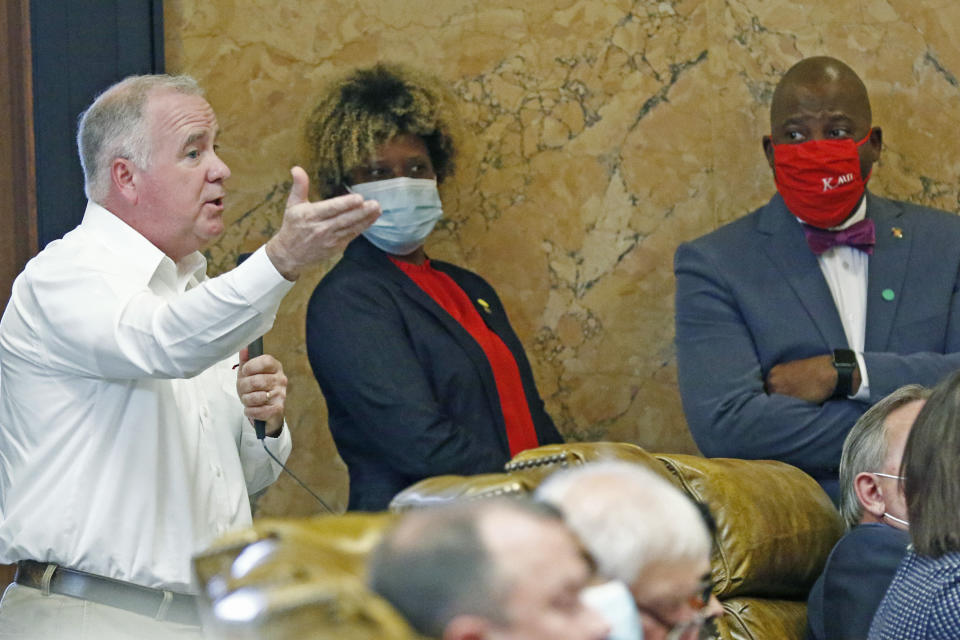 Sens. Sarita Simmons, D-Cleveland, center and Derrick Simmons, D-Greenville, right, listen as Rep. Mark Tullos, R-Raleigh, asks a question during discussion on the bill to change the Mississippi state flag Sunday, June 28, 2020 at the Capitol in Jackson, Miss. The bill passed 92-23 and the legislation headed to the Senate for their consideration. The current flag has in the canton portion of the banner the design of the Civil War-era Confederate battle flag, that has been the center of a long-simmering debate about its removal or replacement. (AP Photo/Rogelio V. Solis)