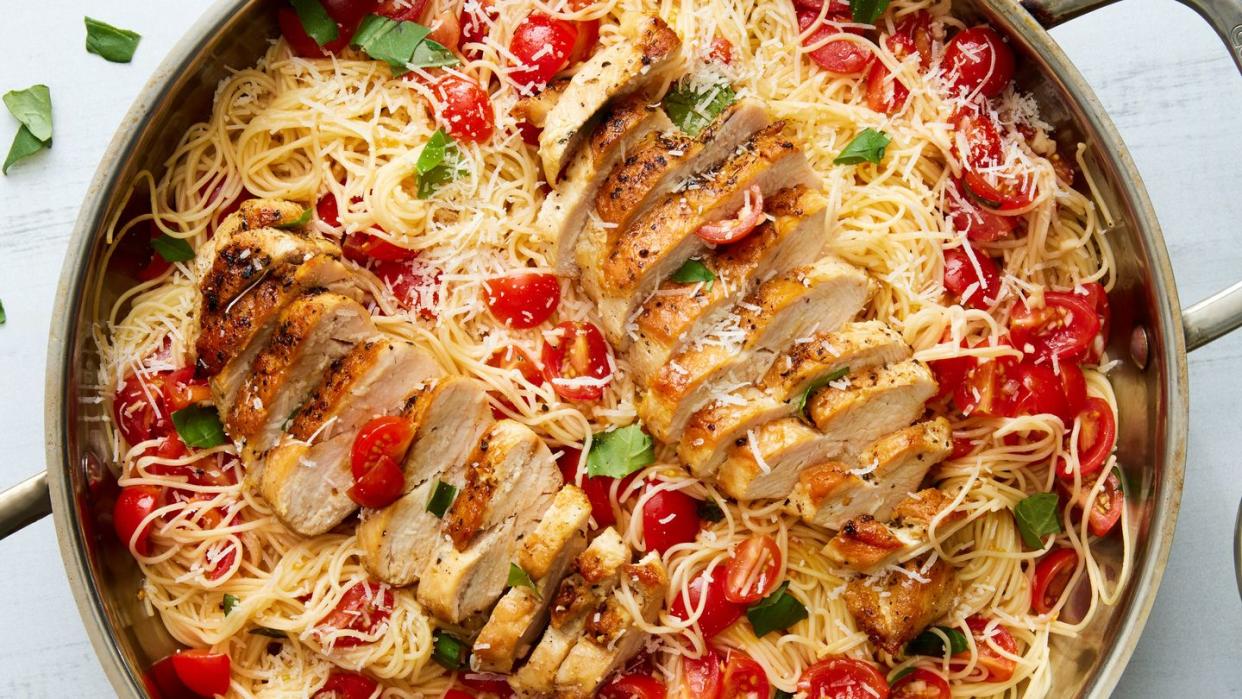 bruschetta chicken pasta topped with fresh herbs and parmesan