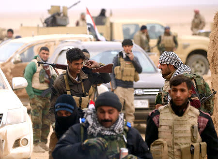 Members of the Lions of the Tigris, a group of Sunni Arab fighters and part of the Hashid Shaabi (Popular Mobilization Comimittee) take part during a military operation against Islamic State militants in Shayyalah al-Imam, Iraq November 30, 2016. REUTERS/Thaier Al-Sudani