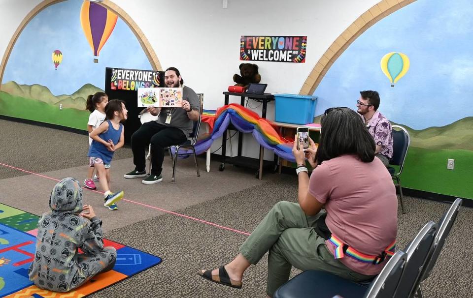 Library assistant Teddy Snyder, left, reads “Pride Puppy!” by Robin Stevenson during Rainbow Story Time at the Stanislaus County Library in Salida, Calif., Thursday, June 15, 2023. Andy Alfaro/aalfaro@modbee.com