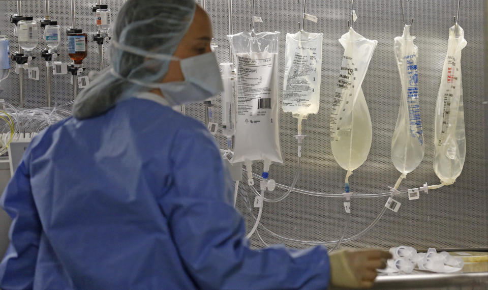 In this Friday, June 1, 2018, photo, a pharmacy technician is shown in the sterile medicines area of the inpatient pharmacy at the University of Utah Hospital in Salt Lake City. (AP Photo/Rick Bowmer)