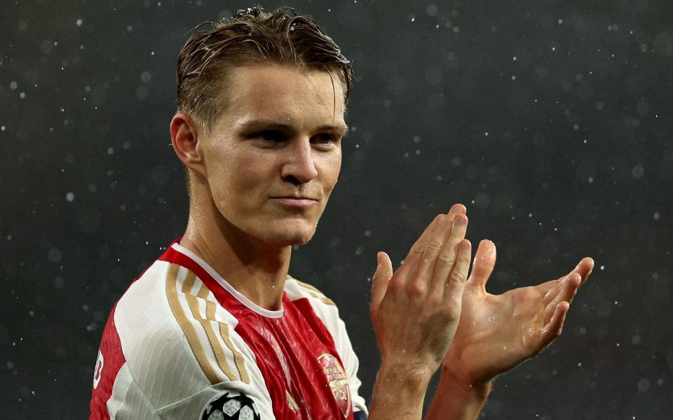 Arsenal's Norwegian midfielder Martin Odegaard applauds the fans following the UEFA Champions League Group B match between Arsenal and PSV Eindhoven at the Arsenal Stadium on September 20