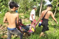 Displaced people carry a sick person in eastern Myanmar's Kayah State