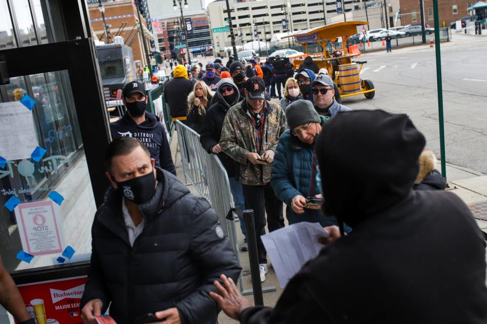 People walk into Tin Roof Detroit, a bar next to Comerica Park, to watch the Tigers game on Opening Day 2021.