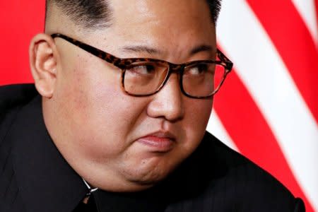 FILE PHOTO: North Korea's leader Kim Jong Un listens to U.S. President Donald Trump as they meet in a one-on-one bilateral session at the start of their summit at the Capella Hotel on the resort island of Sentosa, Singapore June 12, 2018. REUTERS/Jonathan Ernst