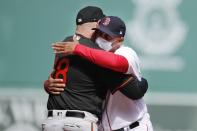 Boston Red Sox manager Alex Cora, right, hugs Baltimore Orioles manager Brandon Hyde before an opening day baseball game, Friday, April 2, 2021, in Boston. (AP Photo/Michael Dwyer)