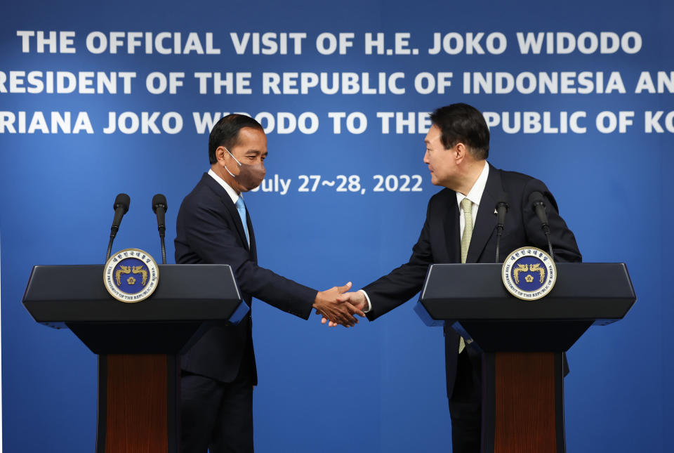 Indonesian President Joko Widodo, left, shakes hands with South Korean President Yoon Suk Yeol after their joint news conference at the presidential office in Seoul, South Korea, Thursday, July 28, 2022. (Suh Myung-gon/Yonhap via AP)