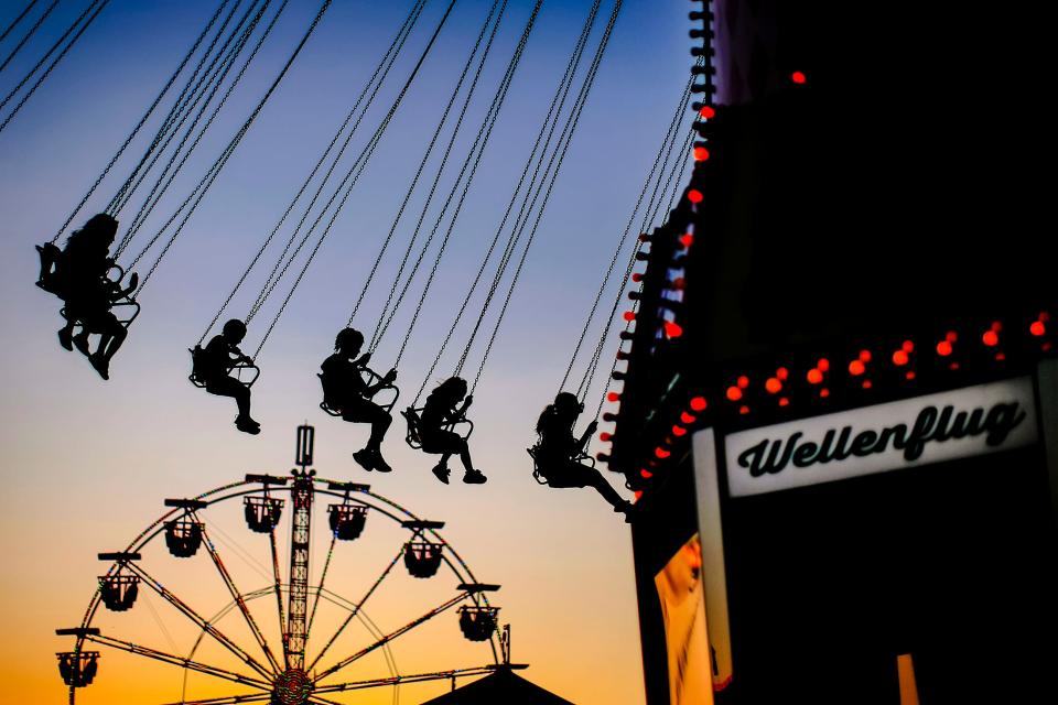 Fairgoers enjoy a ride at the OKC Fairgrounds as the sun sets Sept. 17, 2019, during the Oklahoma State Fair.