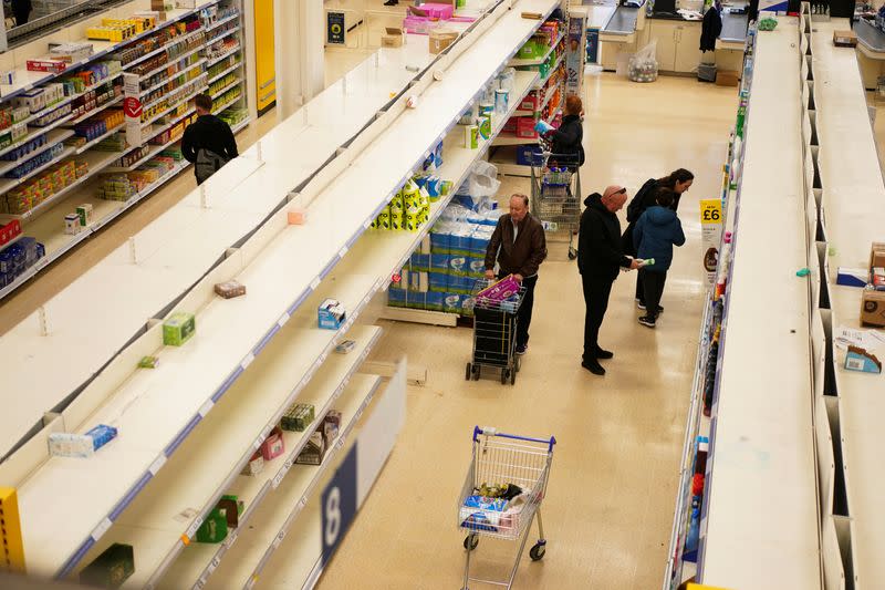 Empty shelves of toilet roll and tissue inside a supermarket, as the number of coronavirus cases grow around the world, in London