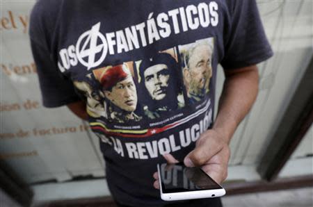 A man uses his mobile phone on a street in Havana April 6, 2014. REUTERS/Enrique De La Osa