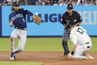 New York Yankees' Joey Gallo (13) slides into second with a double as Seattle Mariners shortstop J.P. Crawford (3) tries to catch the throw during the fourth inning of a baseball game Thursday, Aug. 5, 2021, in New York. (AP Photo/Mary Altaffer)