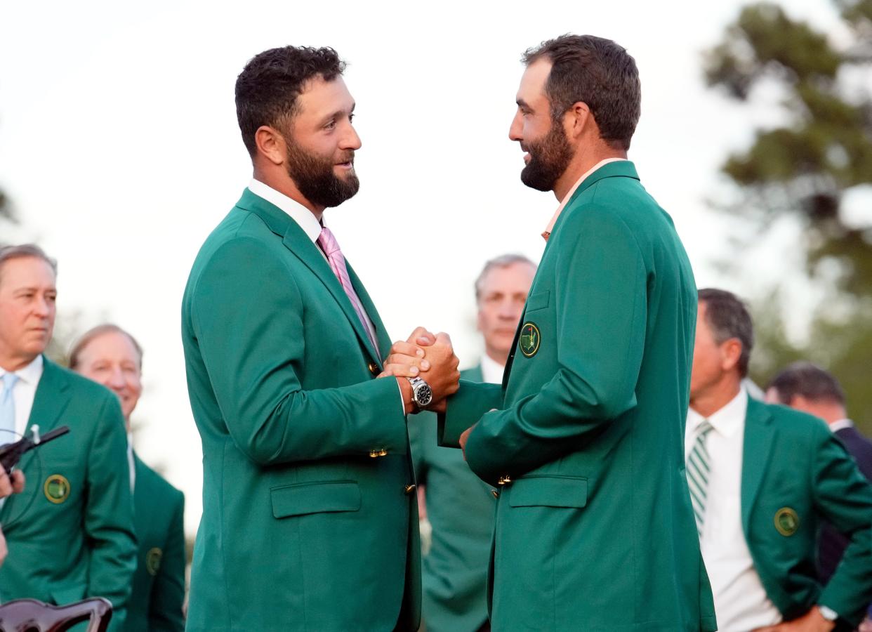 Apr 14, 2024; Augusta, Georgia, USA; 2023 Masters champion Jon Rahm and 2024 Masters champion Scottie Scheffler shake hands during the green jacket ceremony following the final round of the Masters Tournament. Mandatory Credit: Rob Schumacher-USA TODAY Network