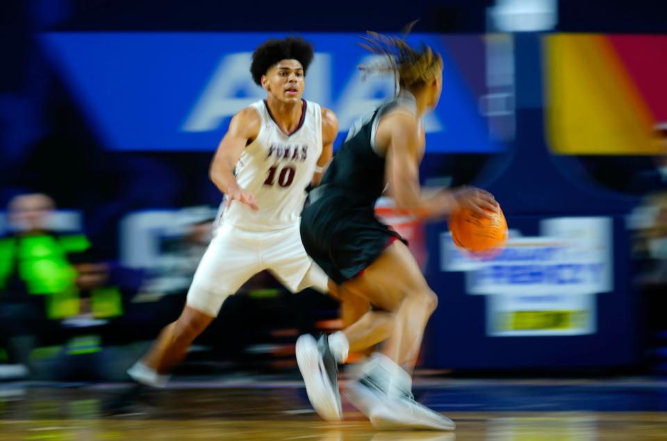 Perry forward Koa Peat (10) defends against Millennium forward Cameron Holmes (3) during the Open State Championship game at Arizona Veterans Memorial Coliseum.