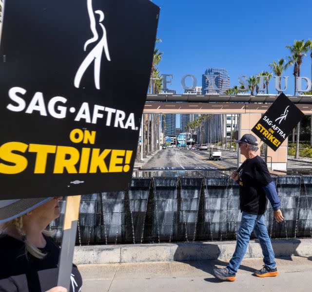 LOS ANGELES, CA - JULY 14: Members of the Hollywood Actors Guild SAG-AFTRA walk in a picket line with screenwriters outside FOX Studios on the second day of the actors' strike on July 14, 2023 in Los Angeles, California.  Members of SAG-AFTRA, Hollywood's largest union representing actors and other media workers, have joined striking WGA (Writers Guild of America) workers in the first joint strike against studios since 1960. The strike could shut down entire Hollywood production with writers in The third month of their strike against Hollywood studios.  (Photo by David McNew/Getty Images)