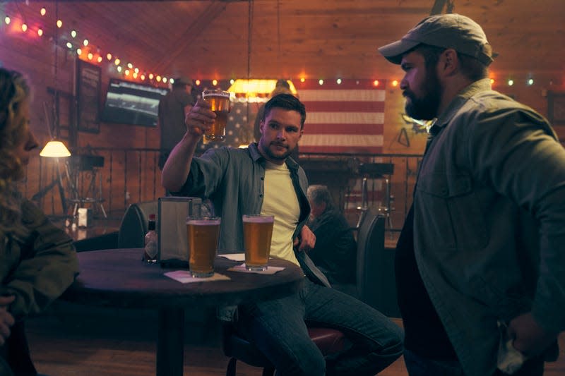 Burton (Jack Reynor) raises a glass in Clanton.