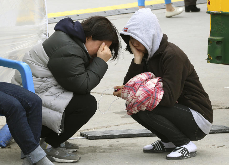 A relative of a passenger aboard the sunken Sewol ferry weeps as she awaits news on her missing loved one at a port in Jindo, South Korea, Tuesday, April 22, 2014. As divers continue to search the interior of the sunken ferry, the number of confirmed deaths has risen, with about 220 other people still missing. (AP Photo/Ahn Young-joon)