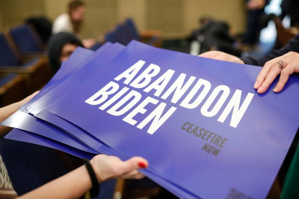 Abandon Biden signs are being distributed during a community rally to boycott President Biden's visit at Fordson High School in Dearborn on Wednesday, Jan. 31, 2024.