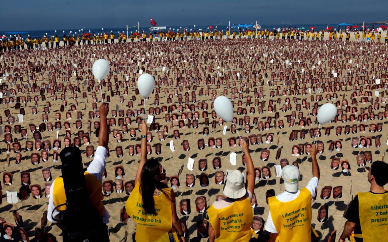 Members of the Baha'i religion demonstrate in Rio de Janeiro's Copacabana beach on June 19, 2011 asking Iranian authorities to release seven Baha'i prisoners accused of spying for Israel and sentenced to 20 years in jail - AFP 