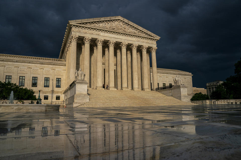 FILE - In this June 20, 2019 file photo, the Supreme Court is seen under stormy skies in Washington. Two issues that could determine the distribution of political power for the next decade await resolution on the Supreme Court's final day of decisions before a long summer break. Chief Justice John Roberts could well be the author of decisions on both politically charged topics Thursday, June 27, whether to allow a citizenship question on the 2020 census and place limits on drawing electoral districts for partisan gain. (AP Photo/J. Scott Applewhite, File)