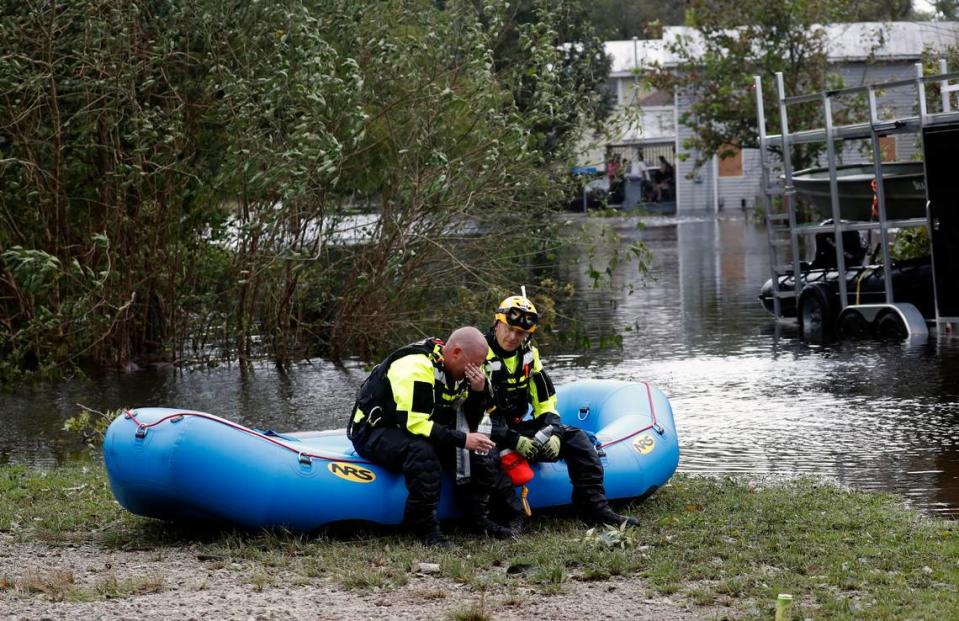 Members of a combined New Bern/Greenville swift water rescue team Brad Johnson, left, and Steve Williams rest after searching for people stranded by floodwaters caused by the tropical storm Florence in New Bern, N.C., on Saturday Sept. 15, 2018.