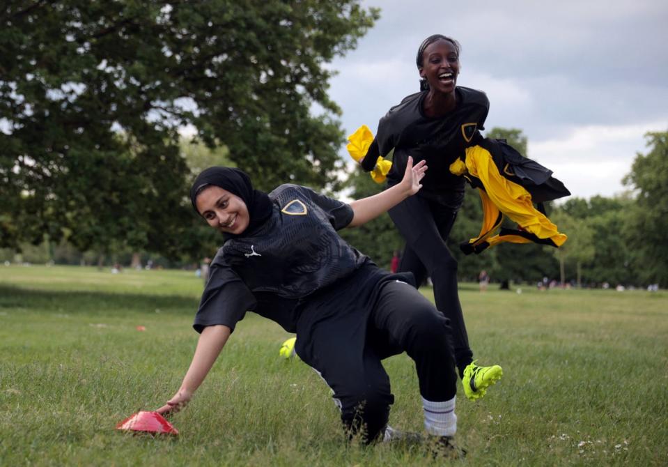 Yasmin chases her teammate Assma Asif, 25, during a training session in Hyde Park (Reuters)